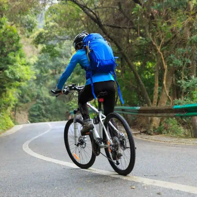 A person riding a bike on a forest road, Sri Lanka